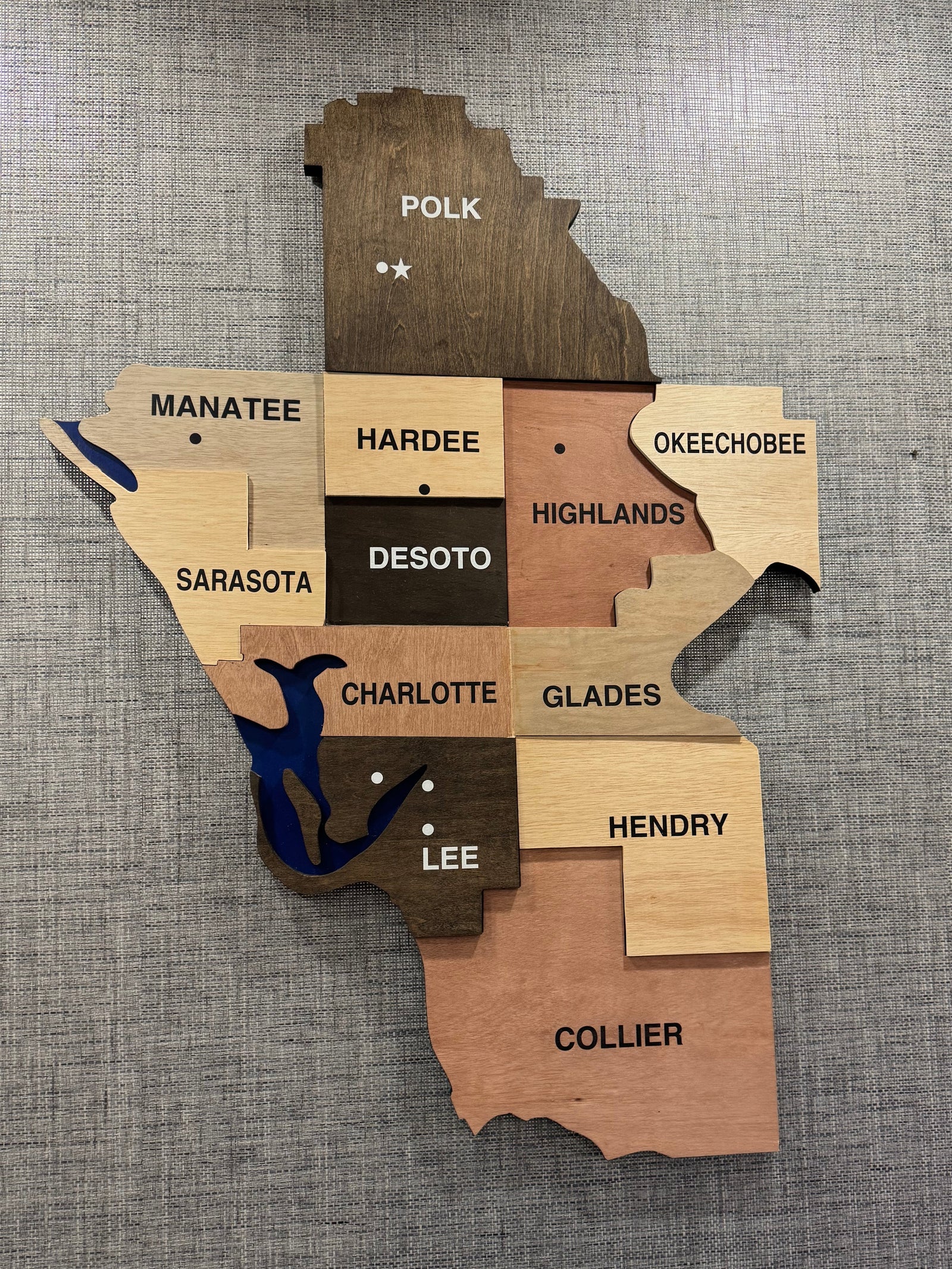 48" tall wood map displayed in a conference room showings the area they serve and locations of satellite offices.