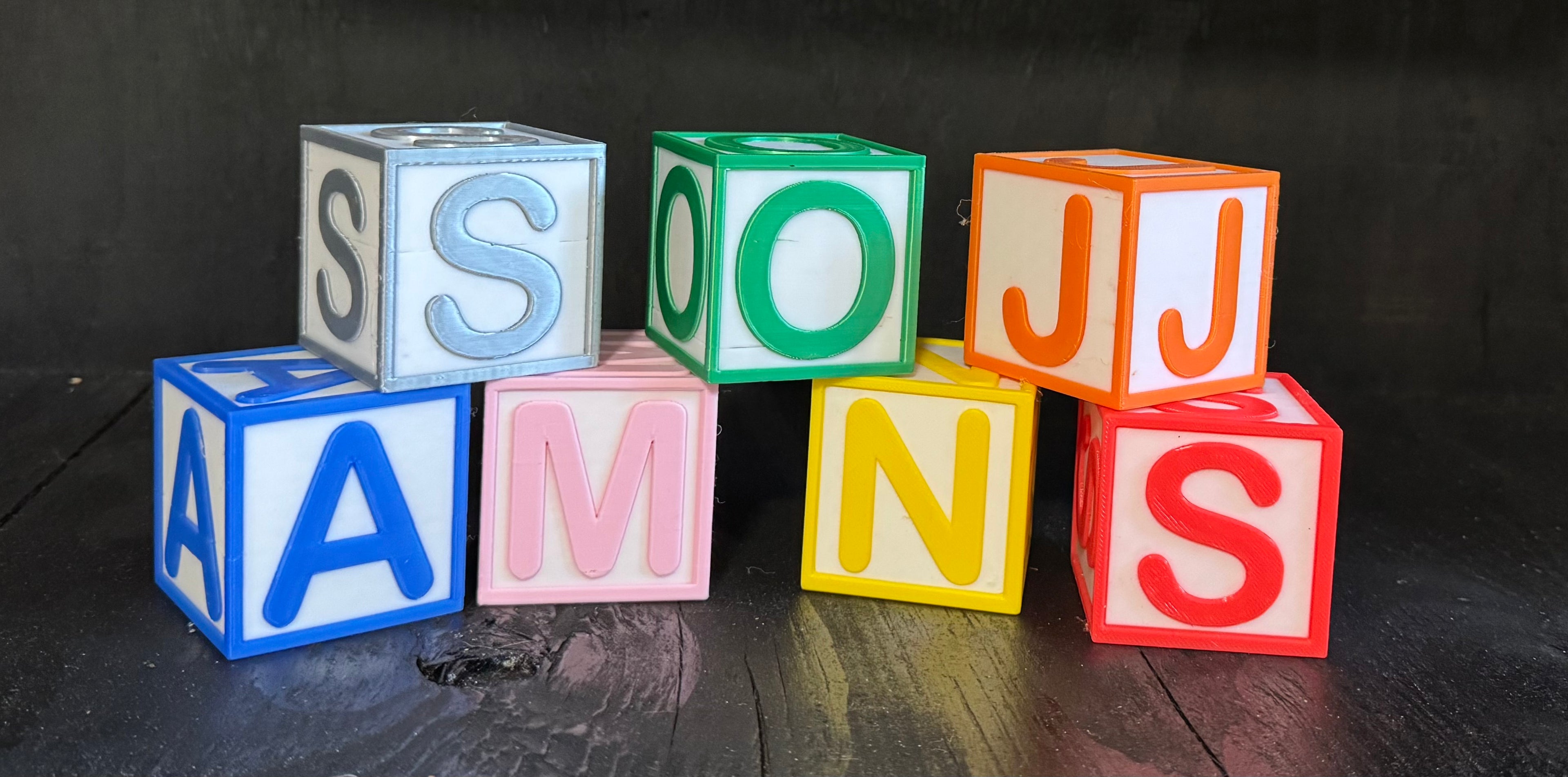 Custom letter blocks spelling JASONS arranged in a stacked display