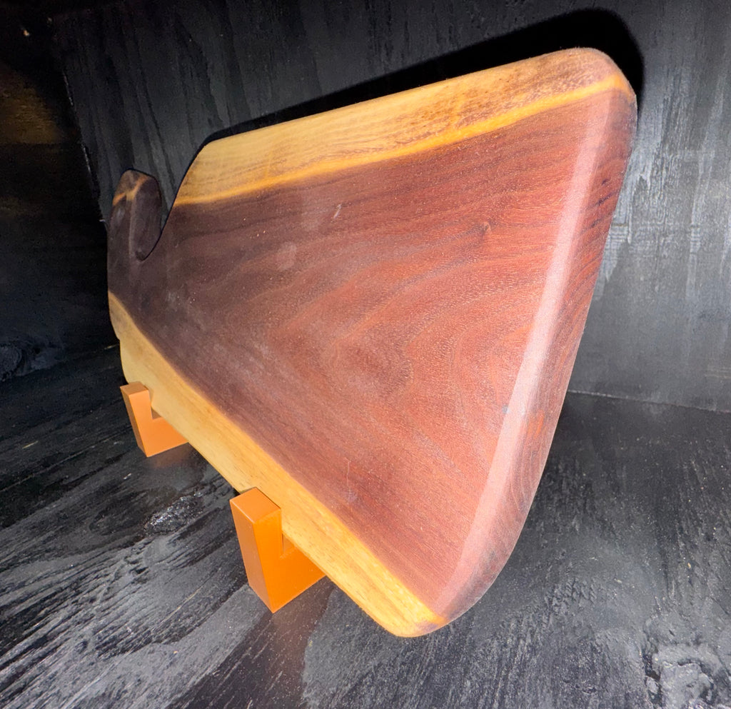 Handcrafted walnut serving board - back view on display stand