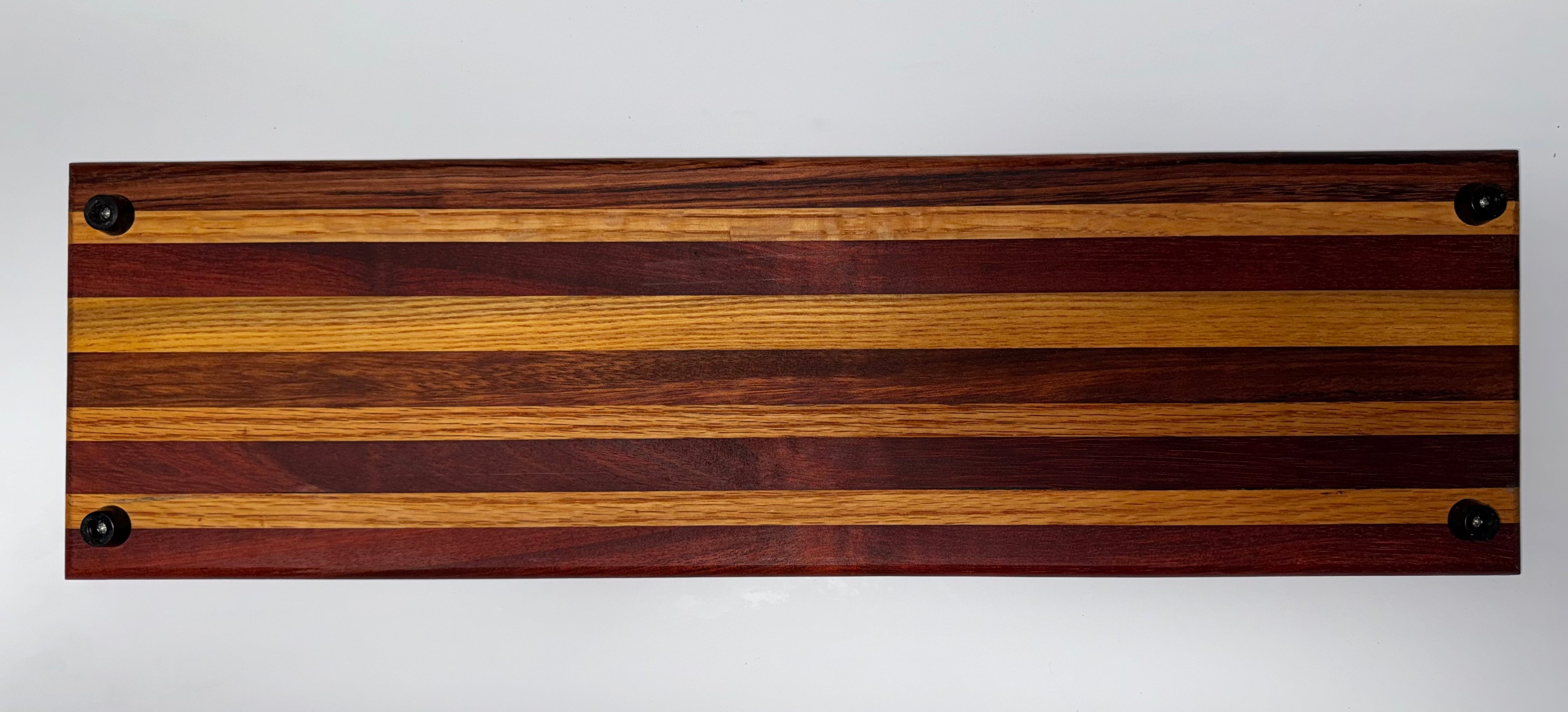 Striped hardwood cutting board with rubber feet - underside view