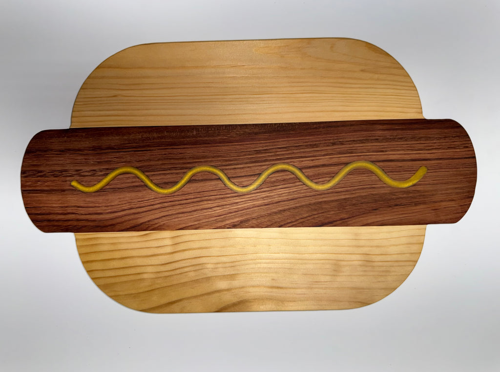 Hot dog shaped cutting board - walnut and maple with mustard squiggle