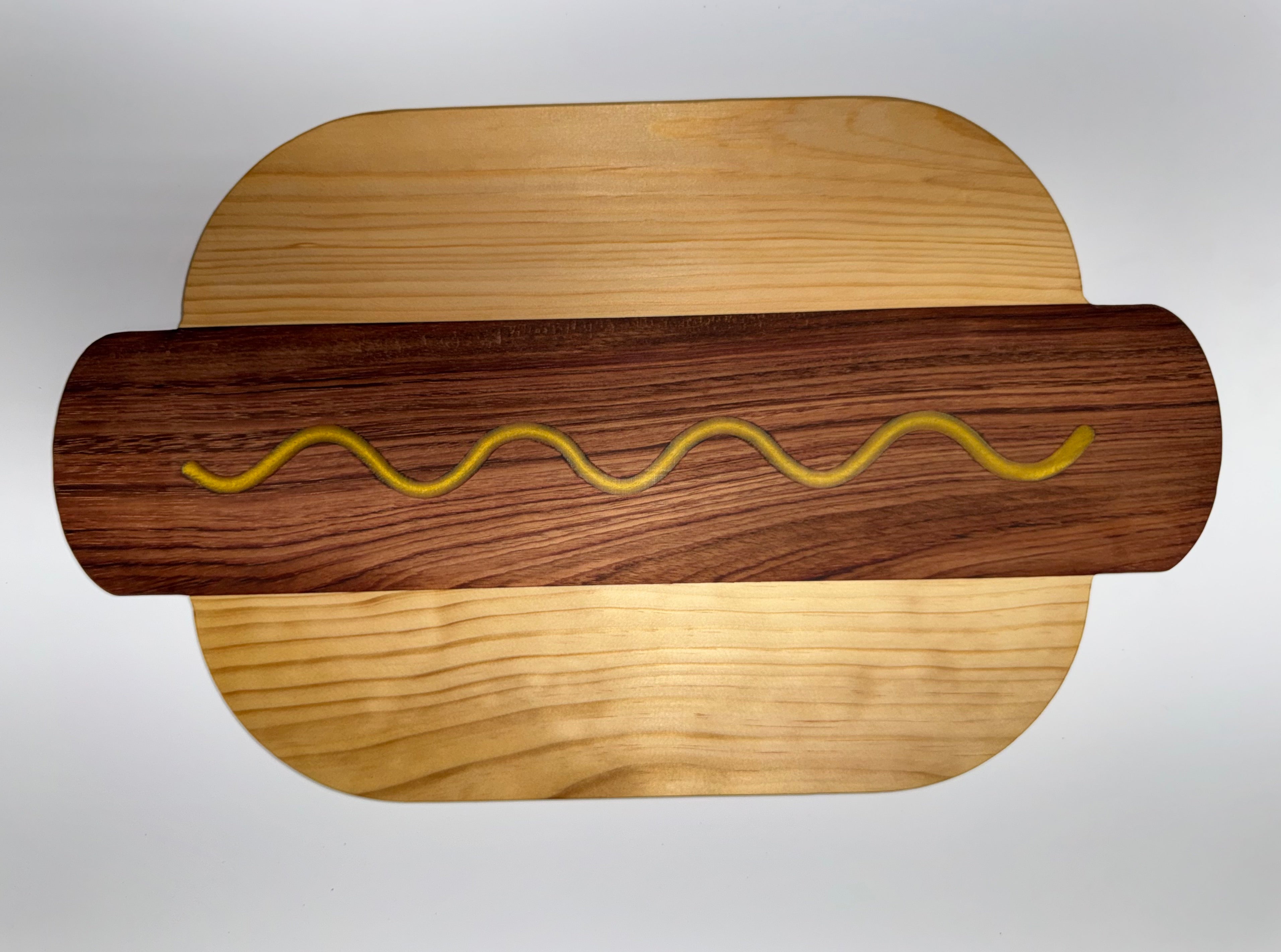 Hot dog shaped cutting board - walnut and maple with mustard squiggle
