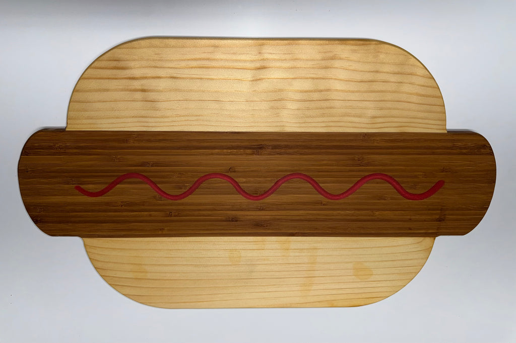 Hot dog shaped cutting board - bamboo with ketchup squiggle