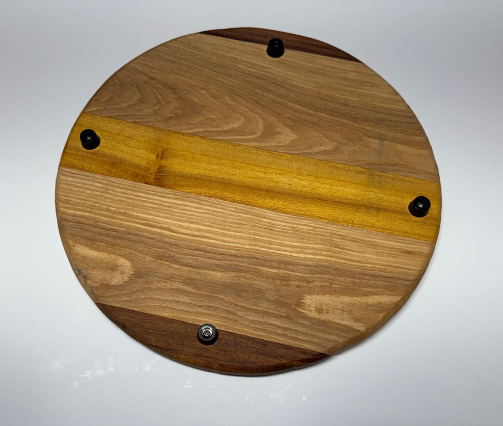 Round multi-species hardwood cutting board - underside showing rubber feet