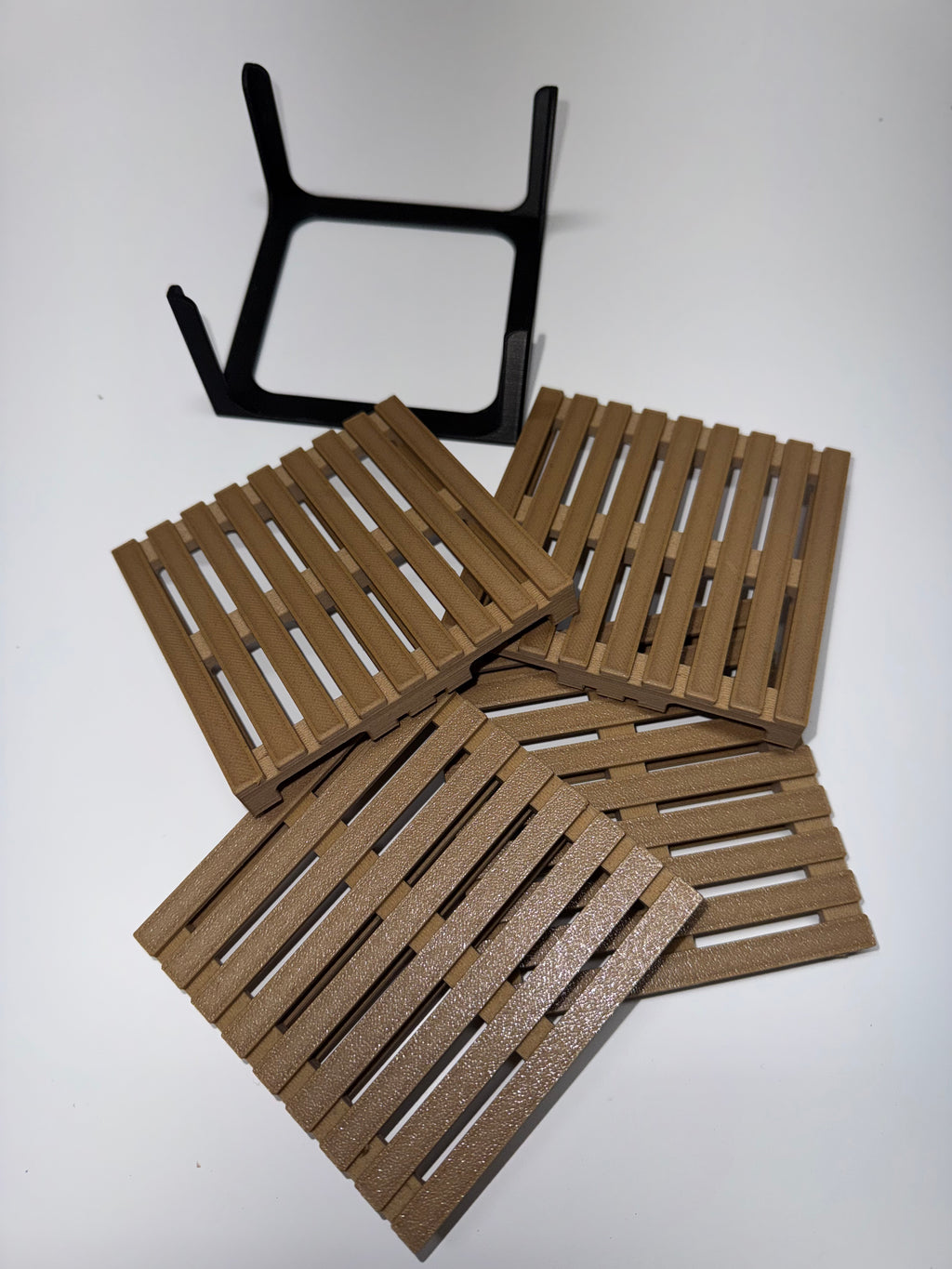 Four mini pallet coasters fanned out with black metal stand