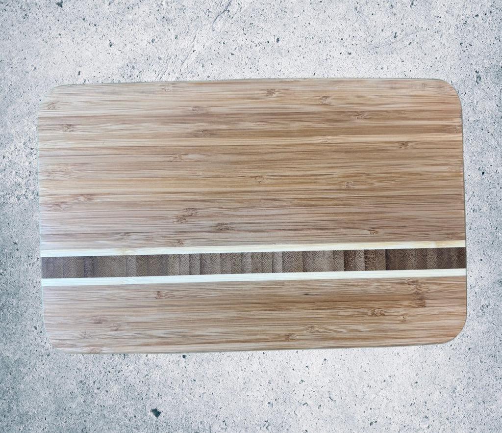 Bamboo cutting board with white resin stripe inlay, flat top-down view