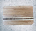 Bamboo cutting board with white resin stripe inlay, flat top-down view