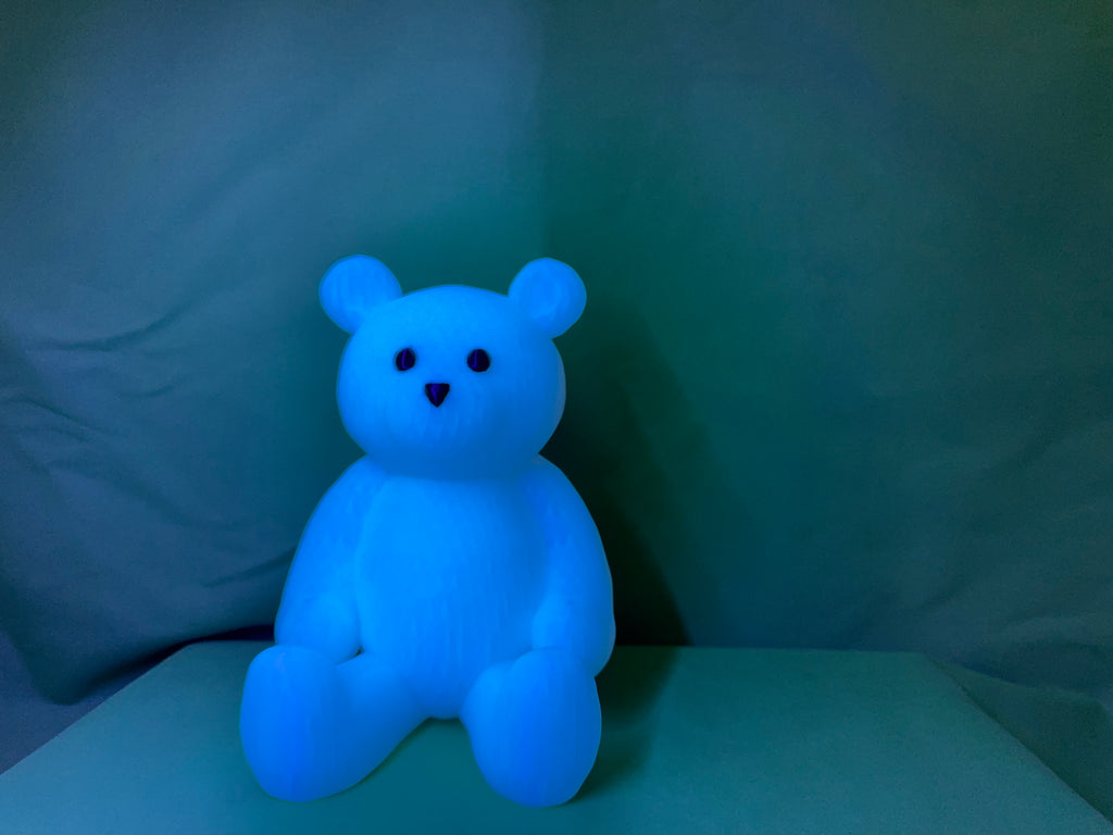 Four glow bears in different colors - blue, pink, green, and purple