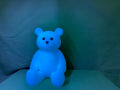 Four glow bears in different colors - blue, pink, green, and purple