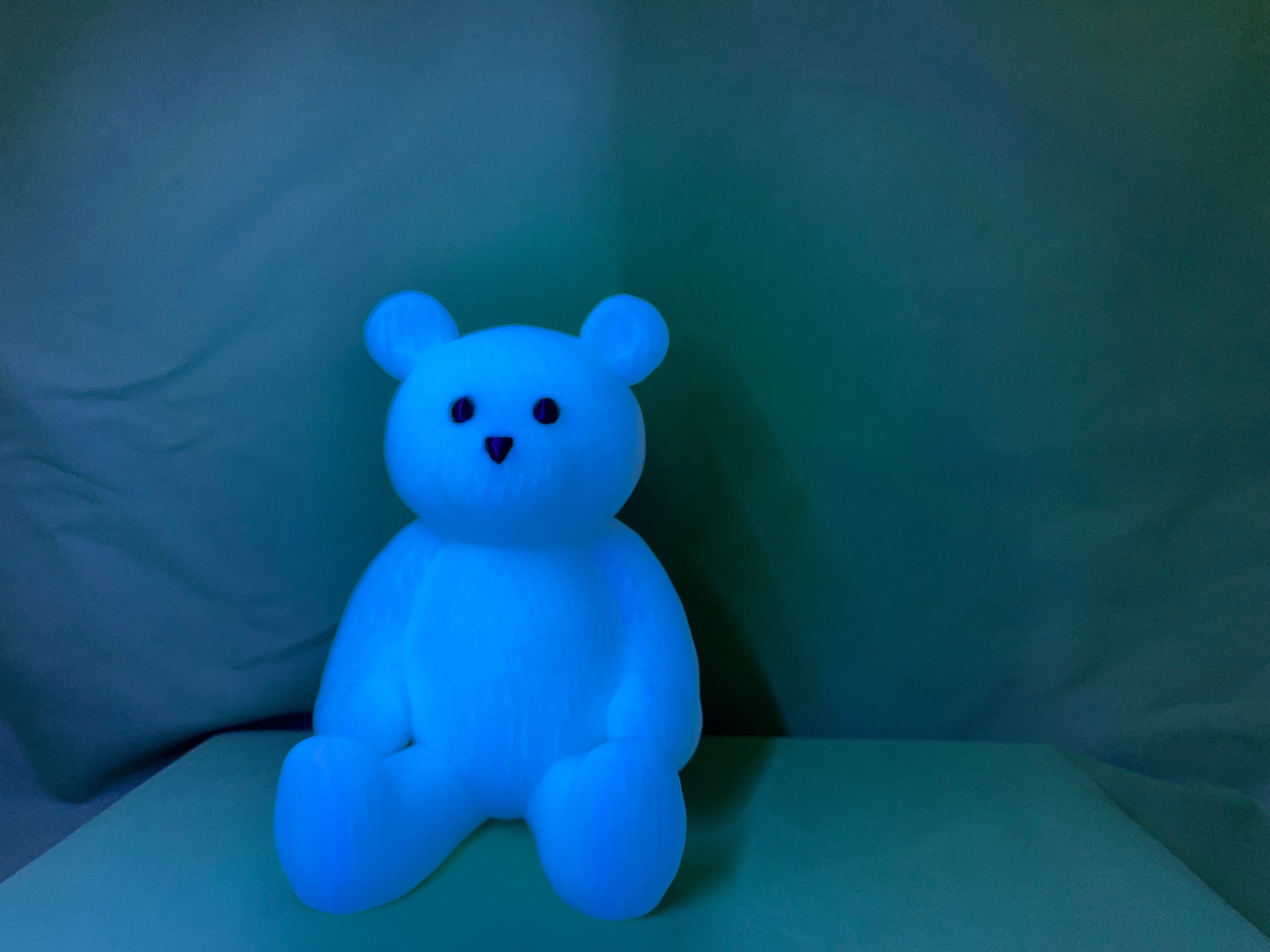 Four glow bears in different colors - blue, pink, green, and purple