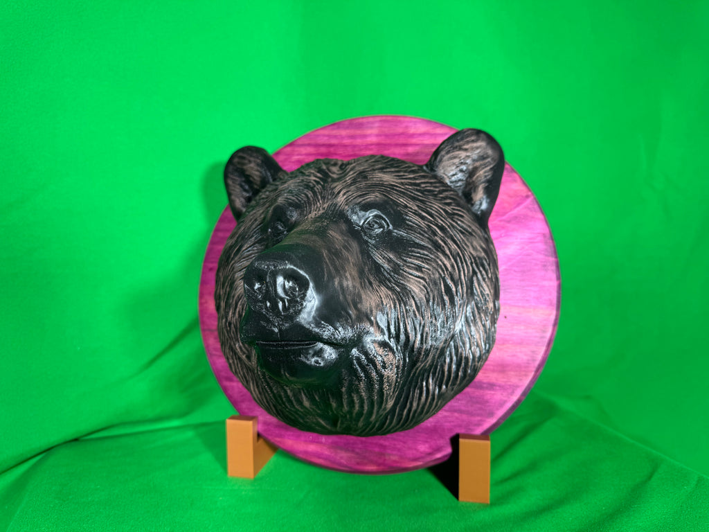 3D printed bear head wall hanging on purple wooden round backplate, front view